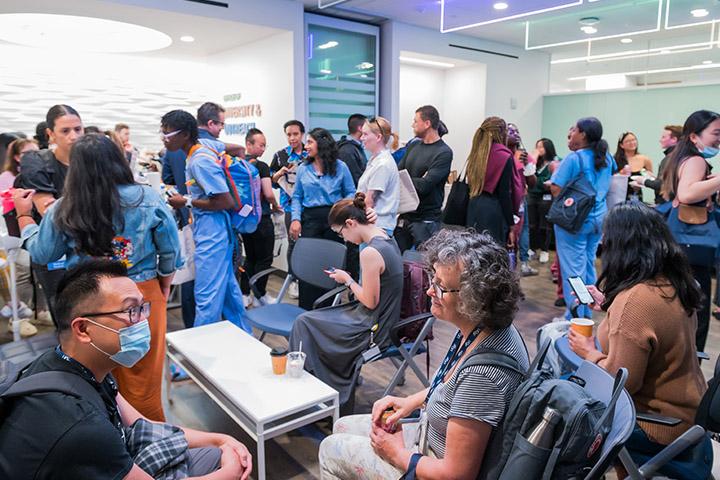 A well-lit indoor space filled with a diverse group of UCSF learners and staff in conversation during the Fall Open House event organized by the UCSF Resource Centers at Parnassus.